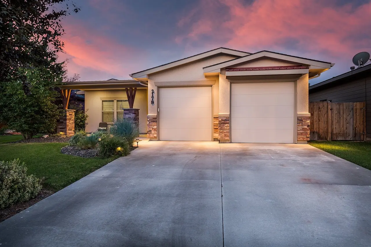 Exterior of refinished home with modern stucco and imitation brick.